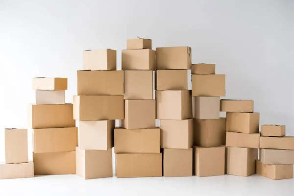 Brown cardboard boxes stacked on each other on white — Stock Photo