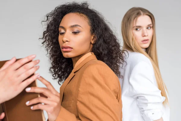 Cropped view of woman holding book near multicultural girls on white — Stock Photo