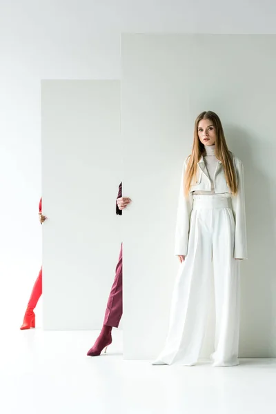 Cropped view of women standing near attractive blonde girl on white — Stock Photo