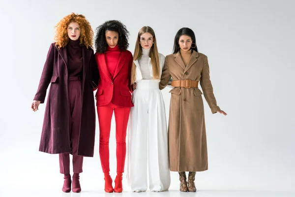 Pretty blonde and redhead women standing with african american girls on white — Stock Photo