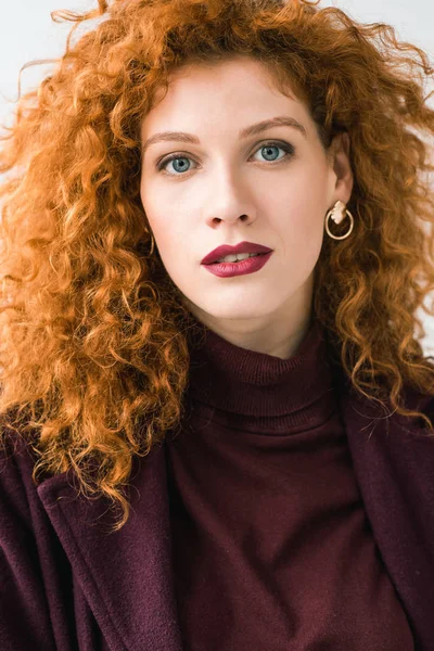 Attractive curly redhead woman looking at camera isolated on white — Stock Photo