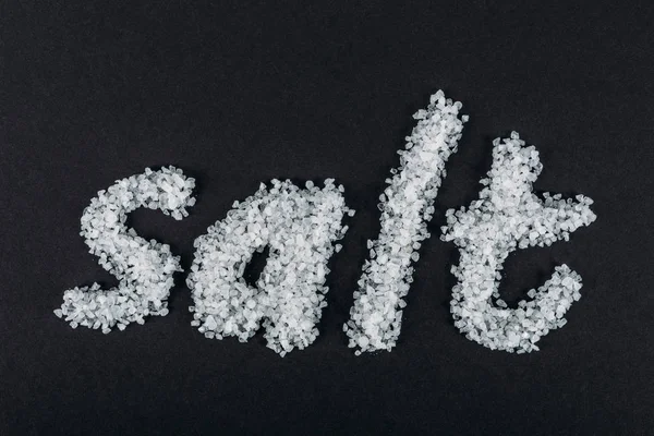 Top view of word salt made of salt crystals on black background — Stock Photo