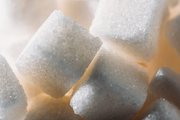 Close up view of lightened refined white sugar cubes — Stock Photo