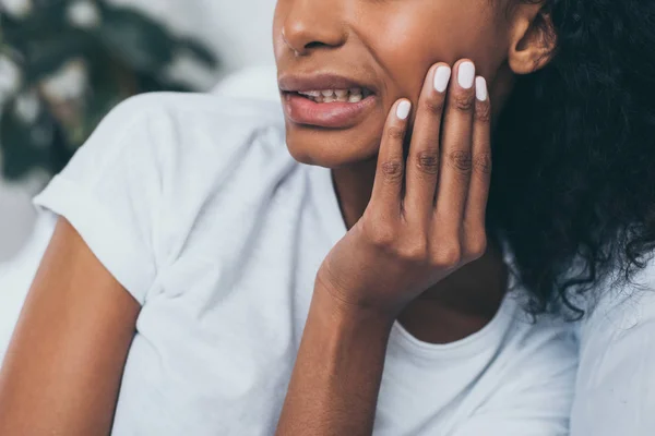 Vue partielle de la jeune femme afro-américaine souffrant de douleur à la mâchoire — Photo de stock