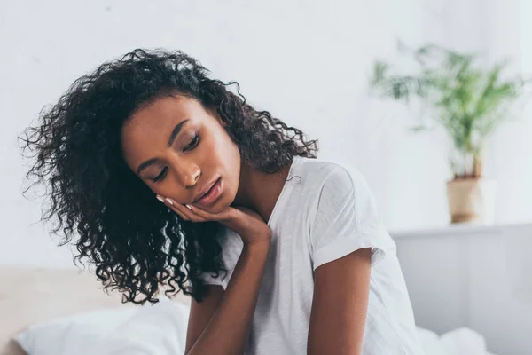 Triste donna afroamericana che soffre di dolore ai denti in camera da letto — Foto stock