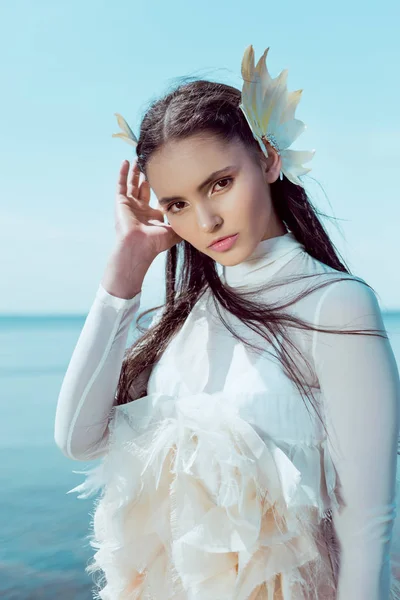 Portrait of tender woman in white swan costume looking at camera — Stock Photo