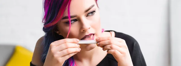 Panoramic shot of beautiful girl licking joint with weed — Stock Photo