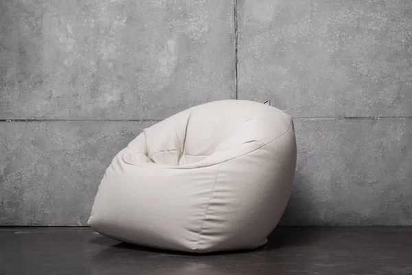 White soft bean bag chair on grey with copy space — Stock Photo