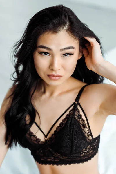 Sexy brunette thai woman in lace black bra looking at camera — Stock Photo