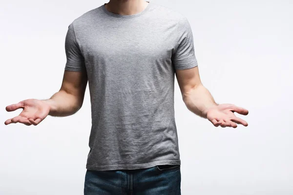 Partial view of man showing shrug gesture isolated on grey, human emotion and expression concept — Stock Photo