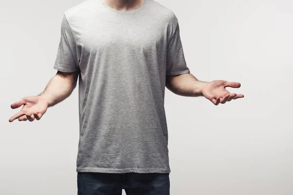 Partial view of man in grey shirt showing shrug gesture isolated on grey, human emotion and expression concept — Stock Photo