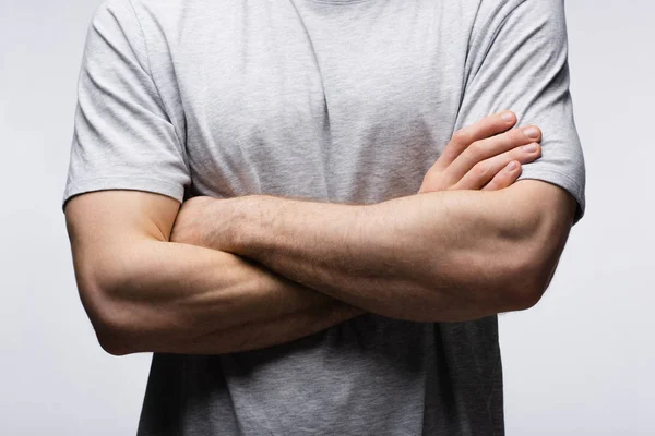 Cropped view of man standing with crossed arms isolated on grey, human emotion and expression concept — Stock Photo