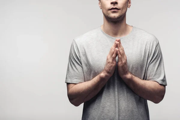 Cropped view of man showing praying gesture isolated on grey, human emotion and expression concept — Stock Photo