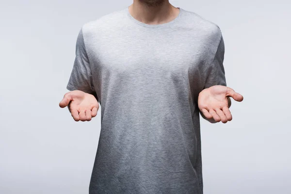 Cropped view of man showing open hands isolated on grey, human emotion and expression concept — Stock Photo
