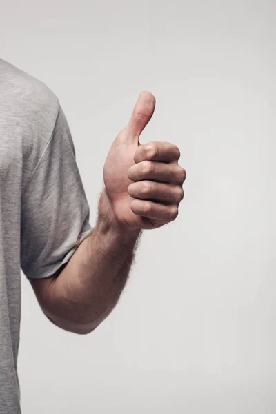 Teilansicht des Menschen, der isoliert den Daumen nach oben zeigt, auf grauem, menschlichem Gefühls- und Ausdruckskonzept — Stockfoto