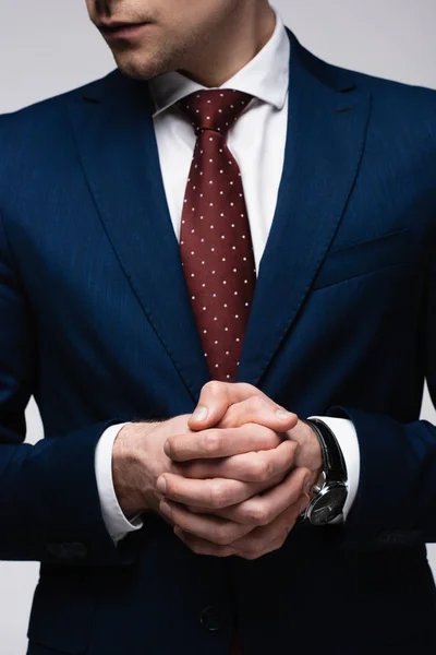 Partial view of confident businessman standing with clenched hands isolated on grey, human emotion and expression concept — Stock Photo