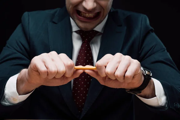 Vista parziale della matita frenante uomo d'affari irritato isolato su nero — Foto stock