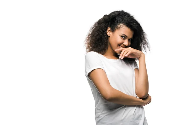 Happy african american girl covering face with hand and looking at camera isolated on white — Stock Photo