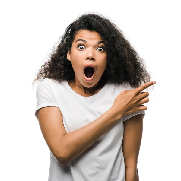 Shocked african american woman pointing with finger isolated on white — Stock Photo