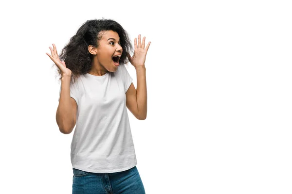 Excited curly african american girl gesturing isolated on white — Stock Photo