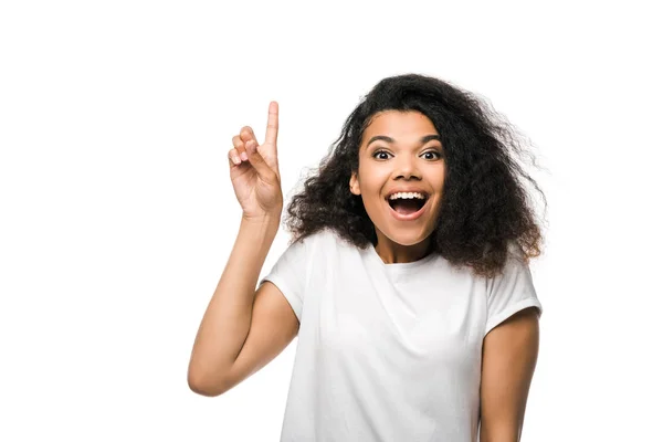 Happy african american woman in white t-shirt pointing with finger isolated on white — Stock Photo