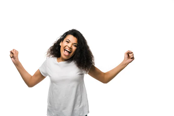 Positive african american woman celebrating and gesturing isolated on white — Stock Photo