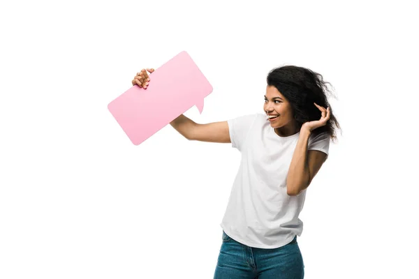 Happy african american girl looking at pink speech bubble isolated on white — Stock Photo