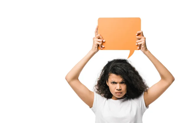 Irritated african american girl holding orange speech bubble isolated on white — Stock Photo