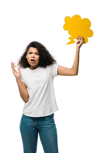 Upset african american girl holding yellow thought bubble isolated on white — Stock Photo