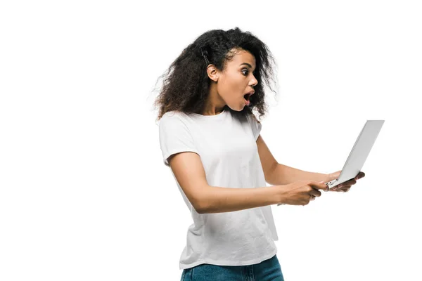 Shocked african american girl looking at laptop isolated on white — Stock Photo