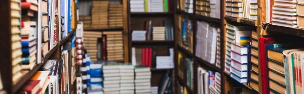 Panoramic shot of retro books on shelves in library — Stock Photo