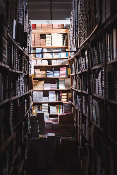 Selective focus of books on wooden shelves in library — Stock Photo