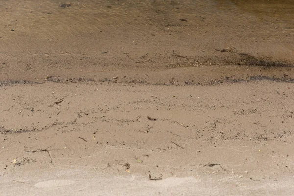 Brown textured surface with sand and water with copy space — Stock Photo