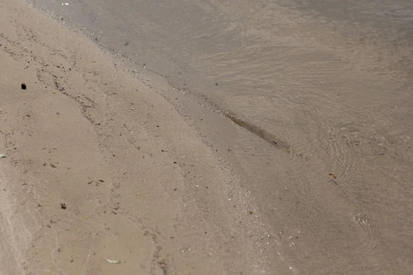 Brown textured surface with sand and water with copy space — Stock Photo