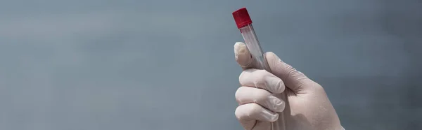 Panoramic shot of water inspector in latex glove holding test tube — Stock Photo