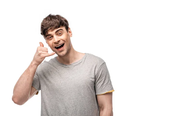 Cheerful young man showing lets drink gesture while smiling at camera isolated on white — Stock Photo
