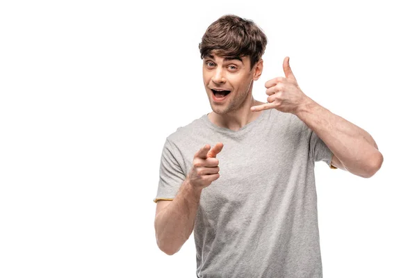 Handsome young man showing lets drink gesture and pointing with finger at camera isolated on white — Stock Photo