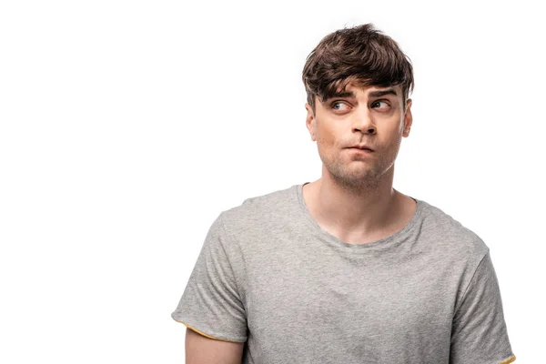 Discouraged young man in grey t-shirt looking away isolated on white — Stock Photo