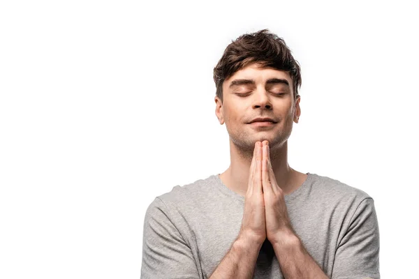 Pensive man with closed eyes showing pray gesture and smiling isolated on white — Stock Photo
