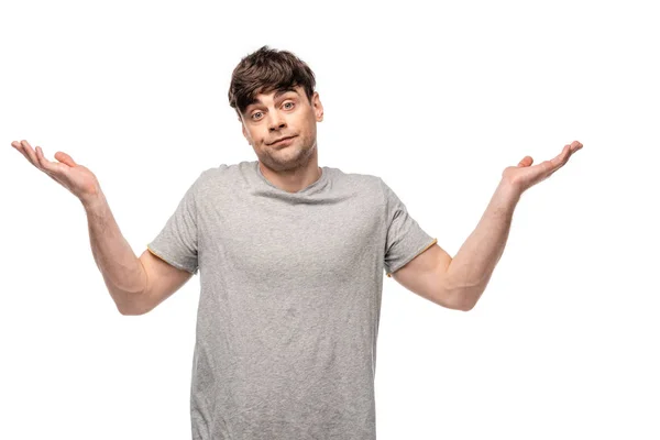 Discouraged young man showing shrug gesture while looking at camera isolated on white — Stock Photo