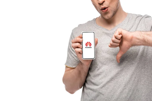 KYIV, UKRAINE - MAY 16, 2019: cropped view of man showing thumb down and smartphone with huawei app, isolated on white — Stock Photo