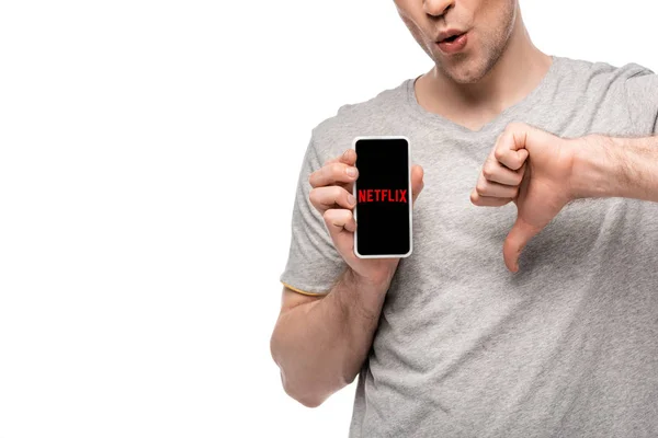 KYIV, UKRAINE - MAY 16, 2019: cropped view of man showing thumb down and smartphone with netflix app, isolated on white — Stock Photo