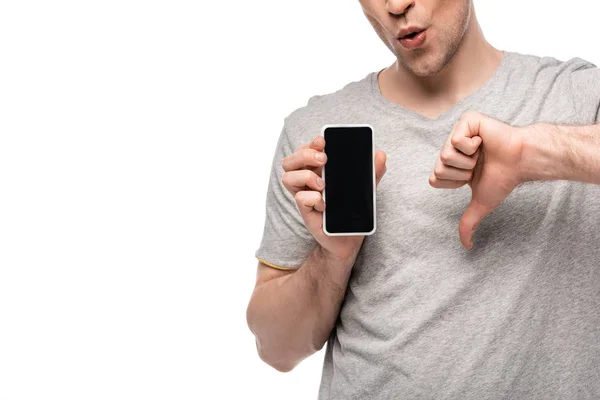 Cropped view of man showing thumb down while holding smartphone with blank screen isolated on white — Stock Photo