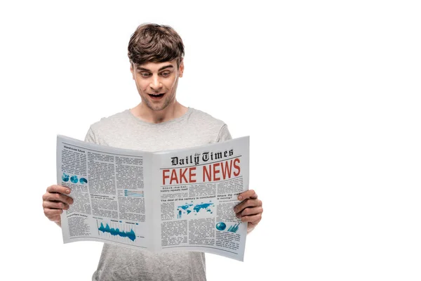 Smiling young man reading smartphone with fake news isolated on white — Stock Photo