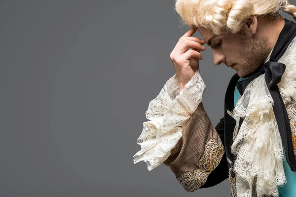 Side view of pensive victorian gentleman in wig thinking isolated on grey — Stock Photo