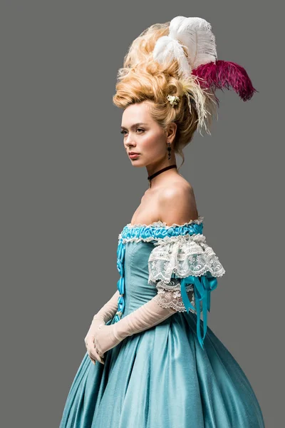 Beautiful victorian woman in wig standing isolated on grey — Stock Photo