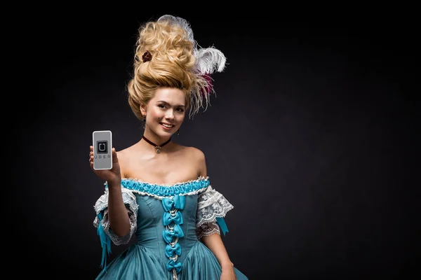 KYIV, UKRAINE - JUNE 5, 2019: happy victorian woman holding smartphone with uber app on screen on black — Stock Photo