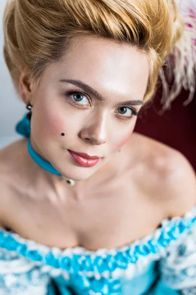 Selective focus of beautiful victorian woman in blue dress looking at camera — Stock Photo