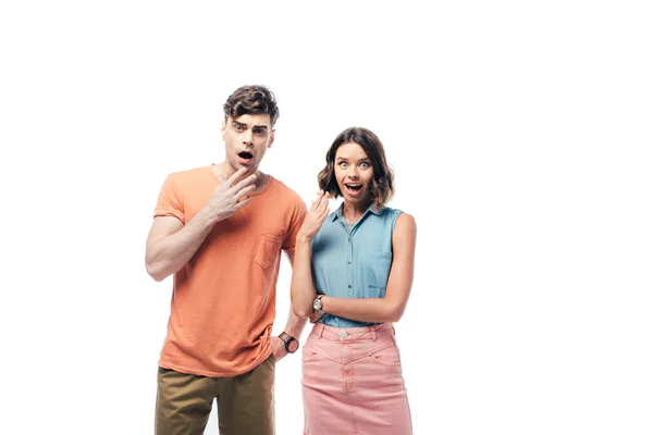 Young, surprised man and woman looking at camera isolated on white — Stock Photo
