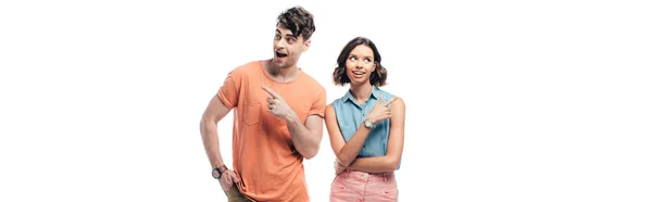 Panoramic shot of cheerful man and woman pointing with fingers and looking away isolated on white — Stock Photo
